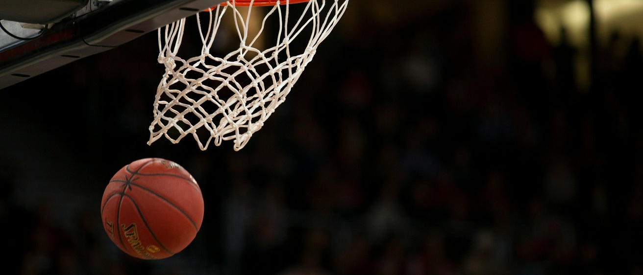 A ball going through a basketball net